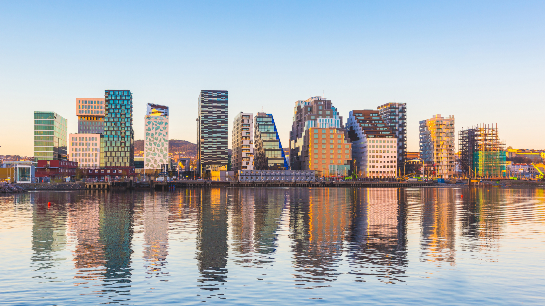 Oslo on a sunny day, with reflections of the buildings reflecting in the water