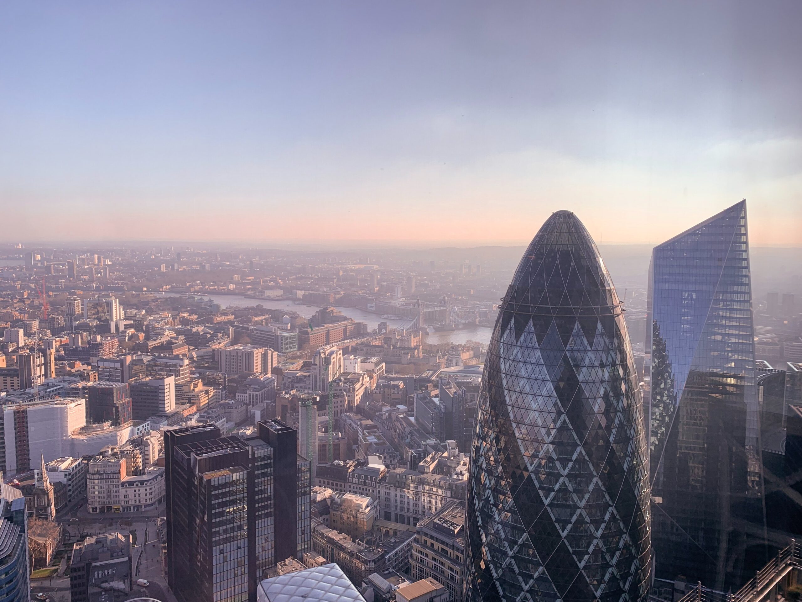 The London skyline including the Gherkin building with a lilac pink sky